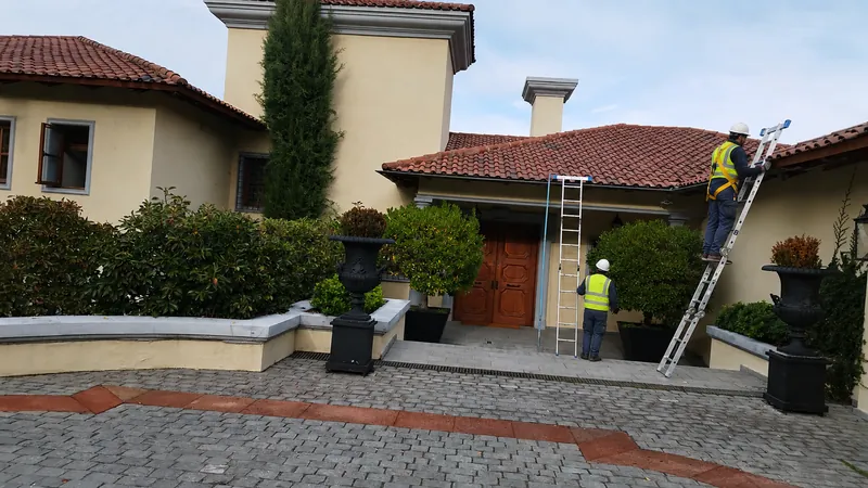 Técnicos inspeccionando un techo de teja romana en Vitacura